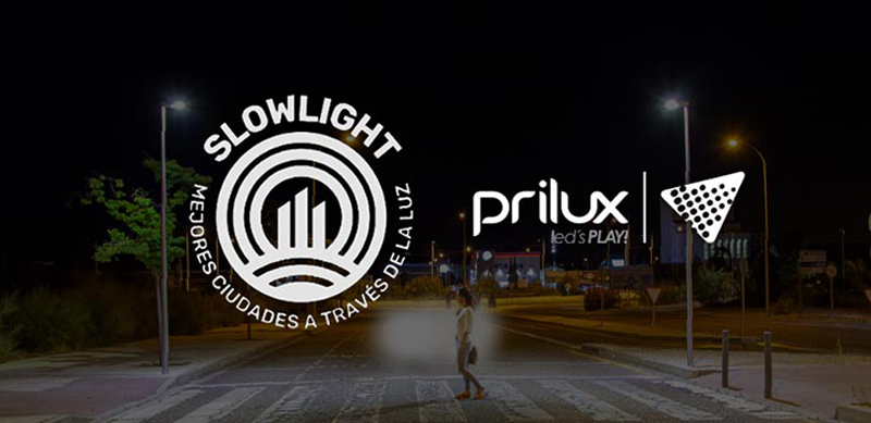 Una calle de noche con iluminación y el logo de Prilux